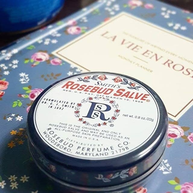 A small tin of salve on a book