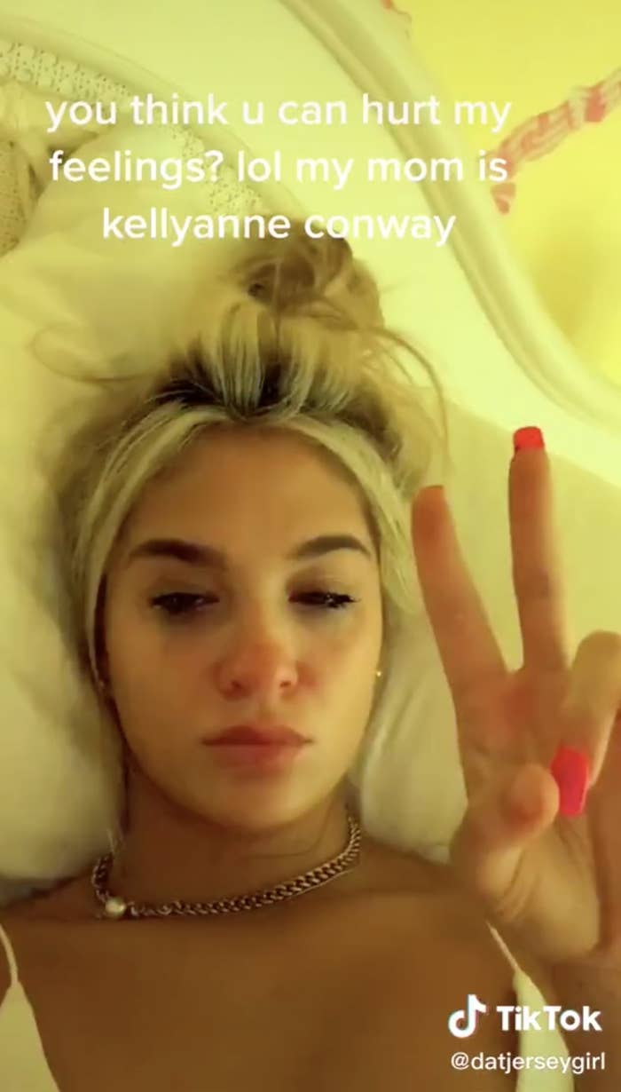 Screenshot from Claudia&#x27;s TikTok making the &quot;peace&quot; sign gesture