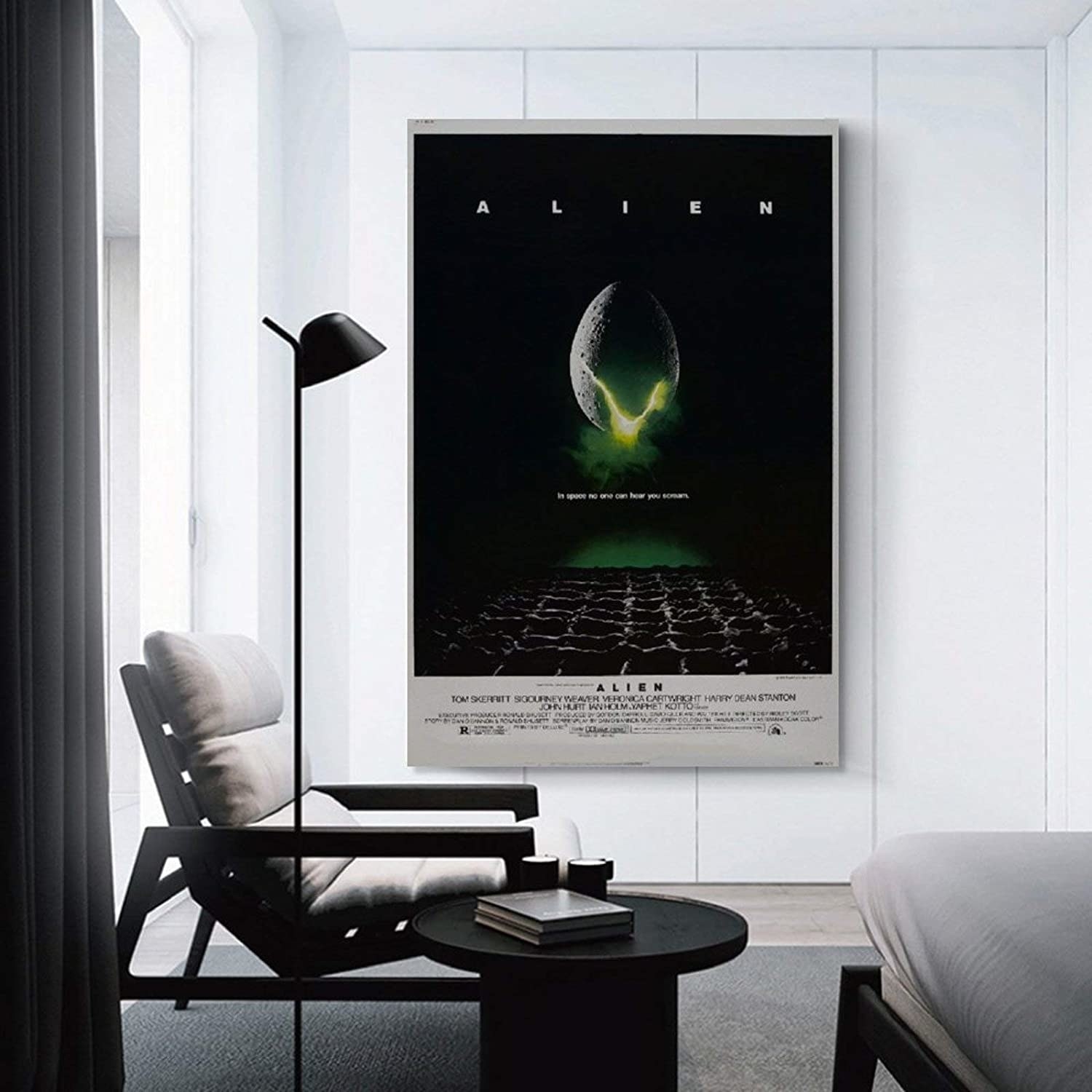 The Alien movie poster hung up on a wall in a living room 