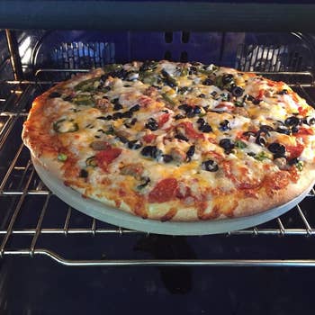 Pizza cooking in the oven on the stone