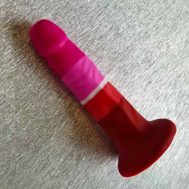 A close-up of the dildo lying on a gray surface