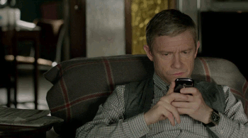 John looking at his phone then up in Sherlock