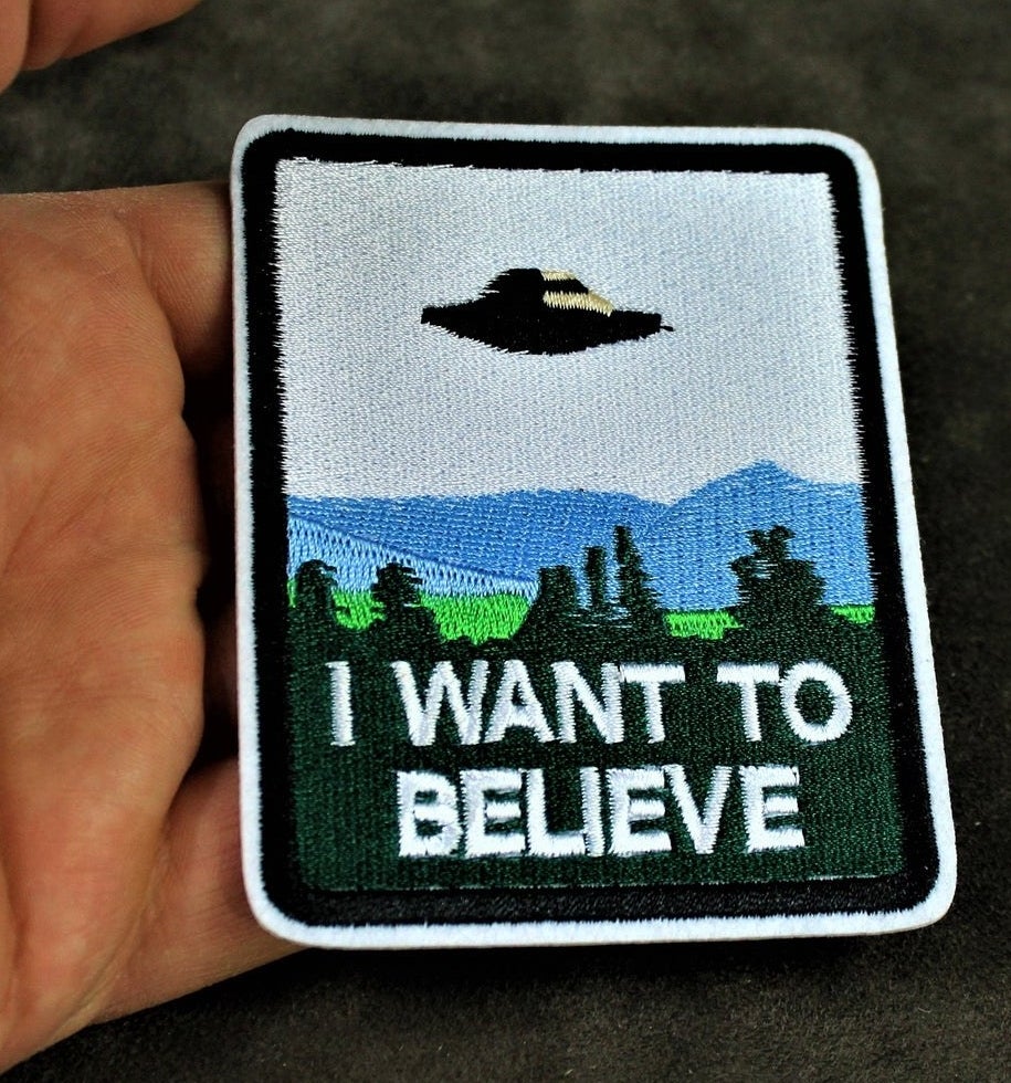 A patch with a UFO and the words I want to believe on it