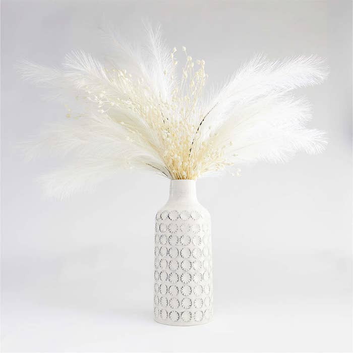 White vase with pampas grass inside