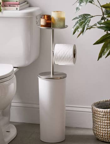 toilet paper holder with a little shelf a storage system for extra rolls