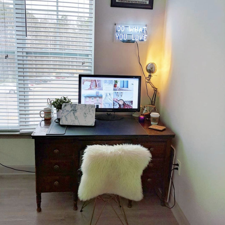 Reviewer image of a white neon "do what you love" sign in a home office" 