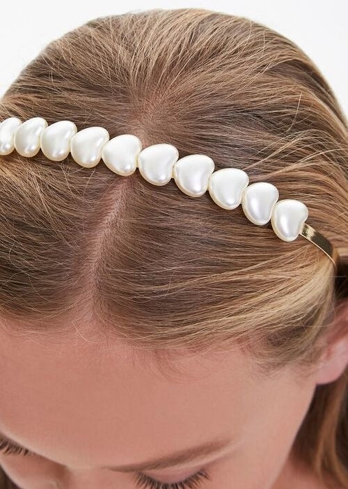 Model wearing a pearl heart headband