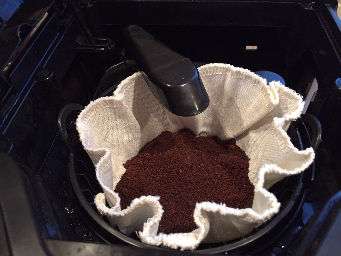 Reusable coffee filter with coffee grinds inside