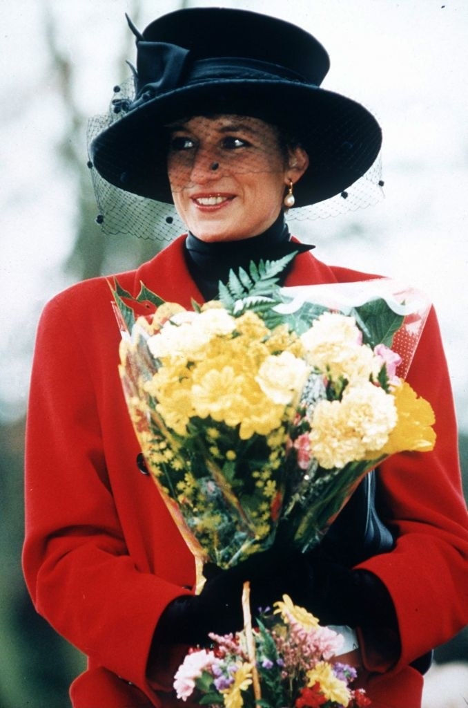 Princess Diana wearing a long winter coat, gloves, and a hat with lace netting covering her face