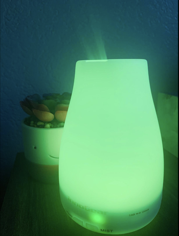 Reviewer image of small diffuser lit up green 