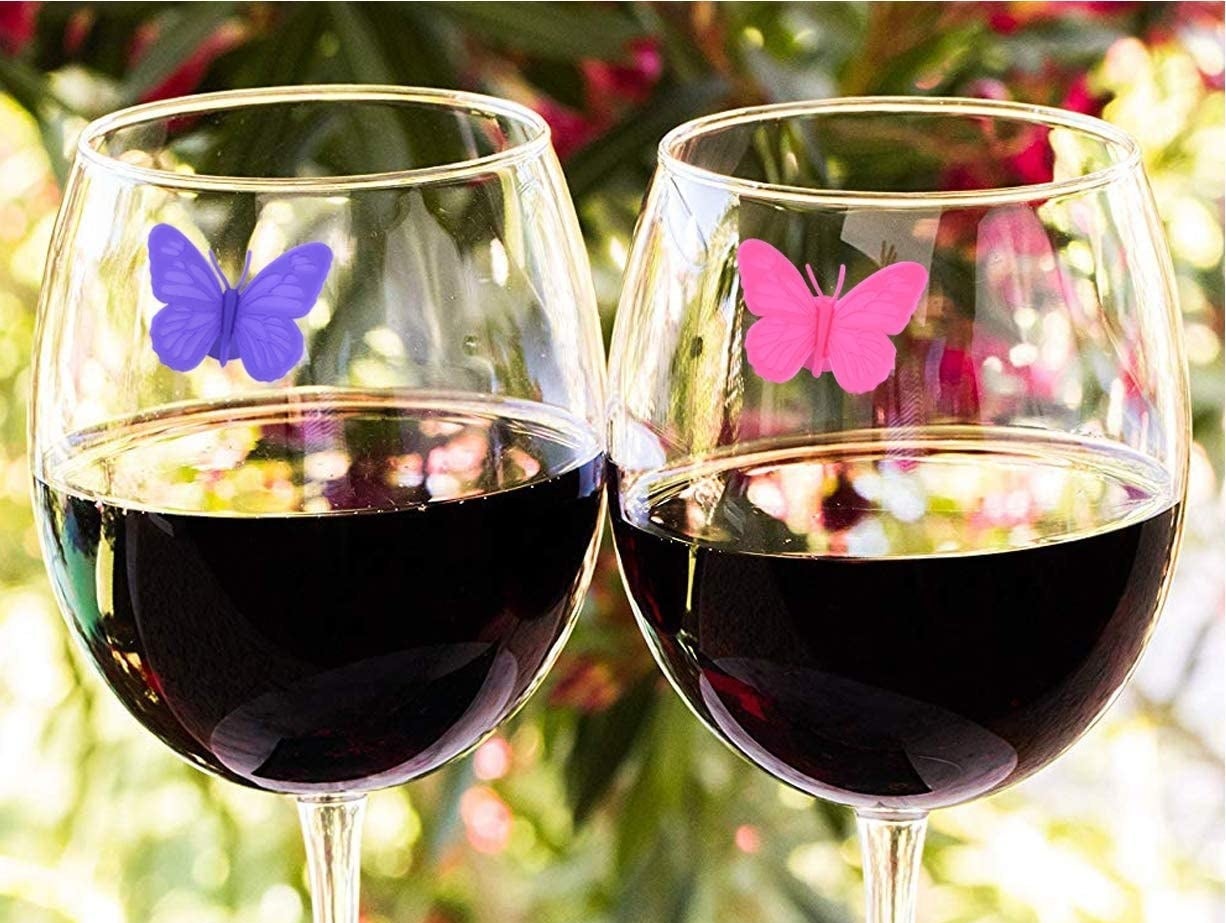 the butterfly markers on two wine glasses