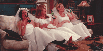 Phoebe, Monica, and Rachel in wedding dresses on Friends