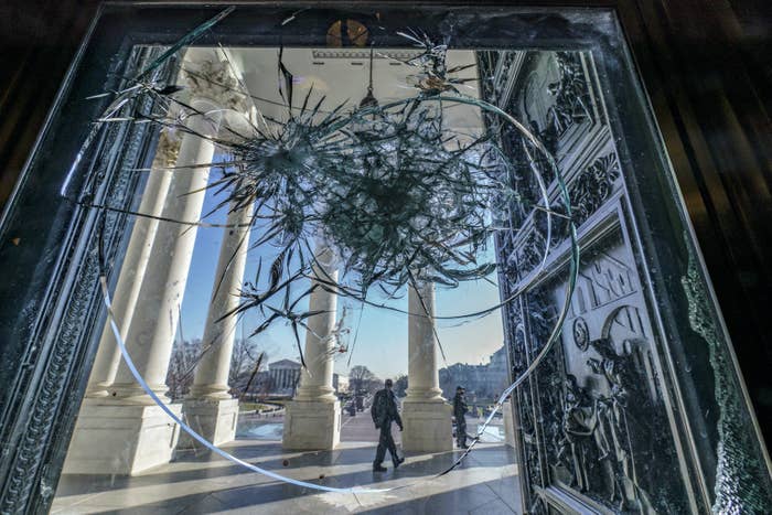 Shattered glass is seen in the doors leading to the Capitol rotunda