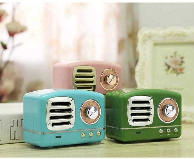 Mini retro-looking radio speakers in blue, green, and pink 
