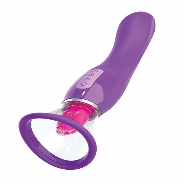 The toy with a long purple handle and a pink tongue inside a clear suction cup head