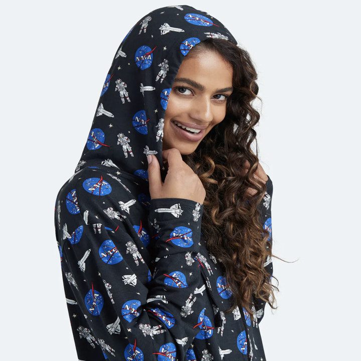 a model wearing a hood in the black onesie with the nasa logo on it
