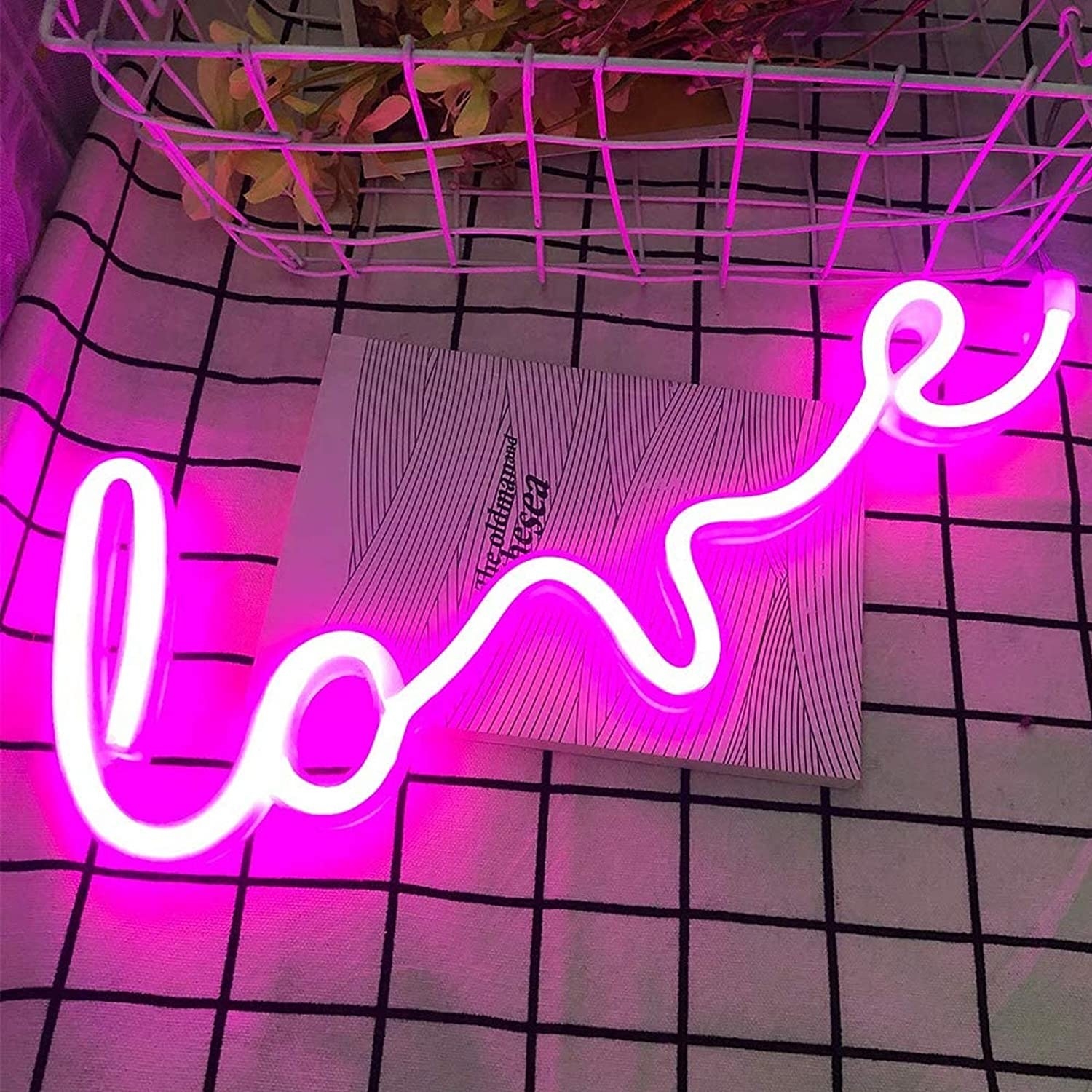 Neon light that says &quot;love&quot; in cursive 