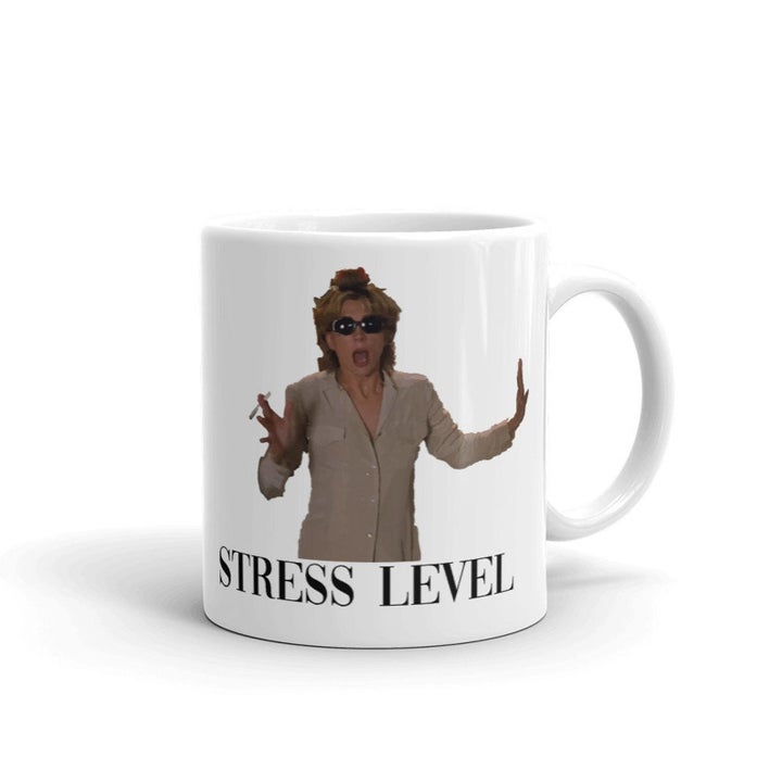 a white mug with natasha richardson on it panicked from a scene in the parent trap with "stress level" written below her