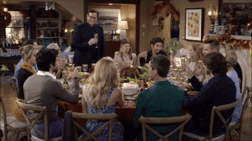 A family sits around the table on Thanksgiving