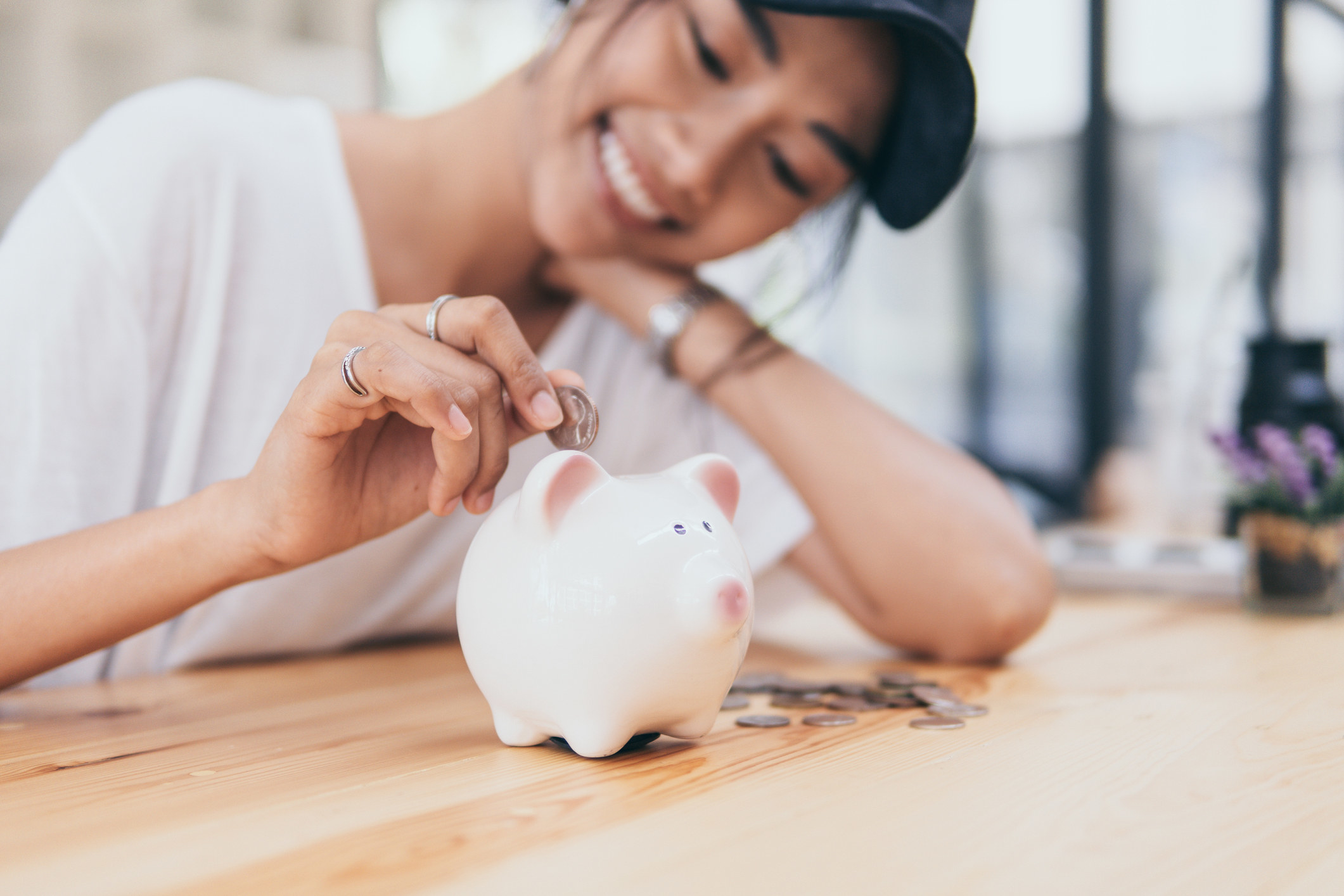 Model putting money into a piggy bank