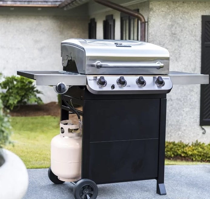 The grill sitting outside in the backyard