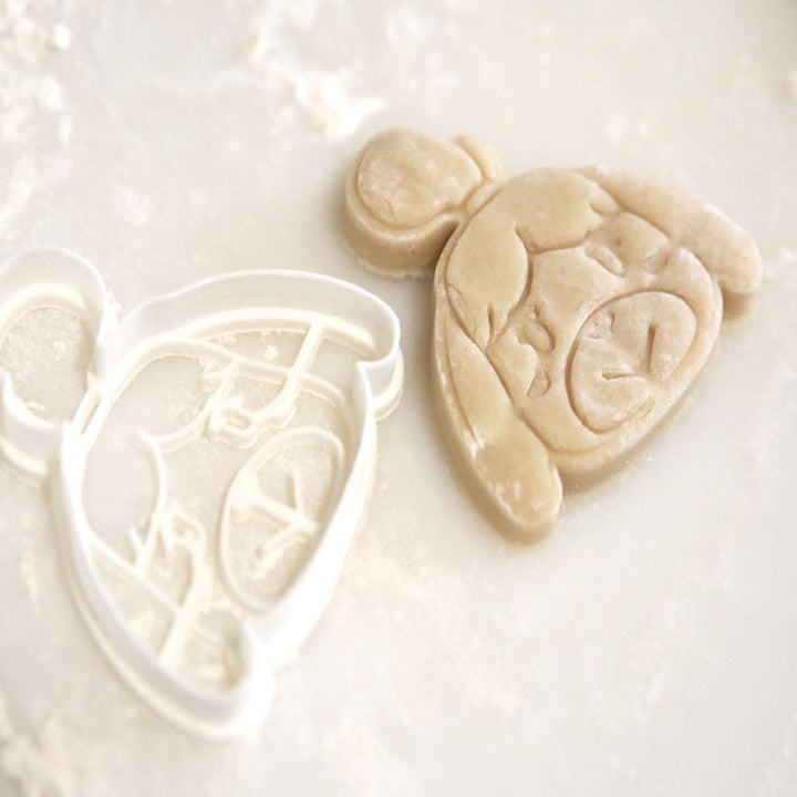 an isabelle cookie cutter next to an isabelle sugar cookie