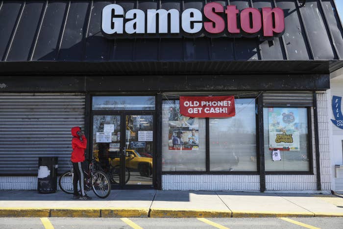 A young boy waits outside of GameStop to pick up a purchase