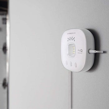 MyQ smart garage door opener hanging on wall