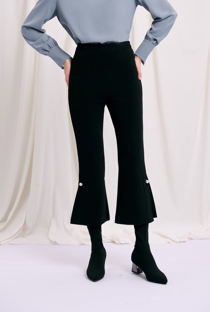 A model in the high waisted pants in black