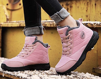 Model in a pair of pastel pink lace up boots 