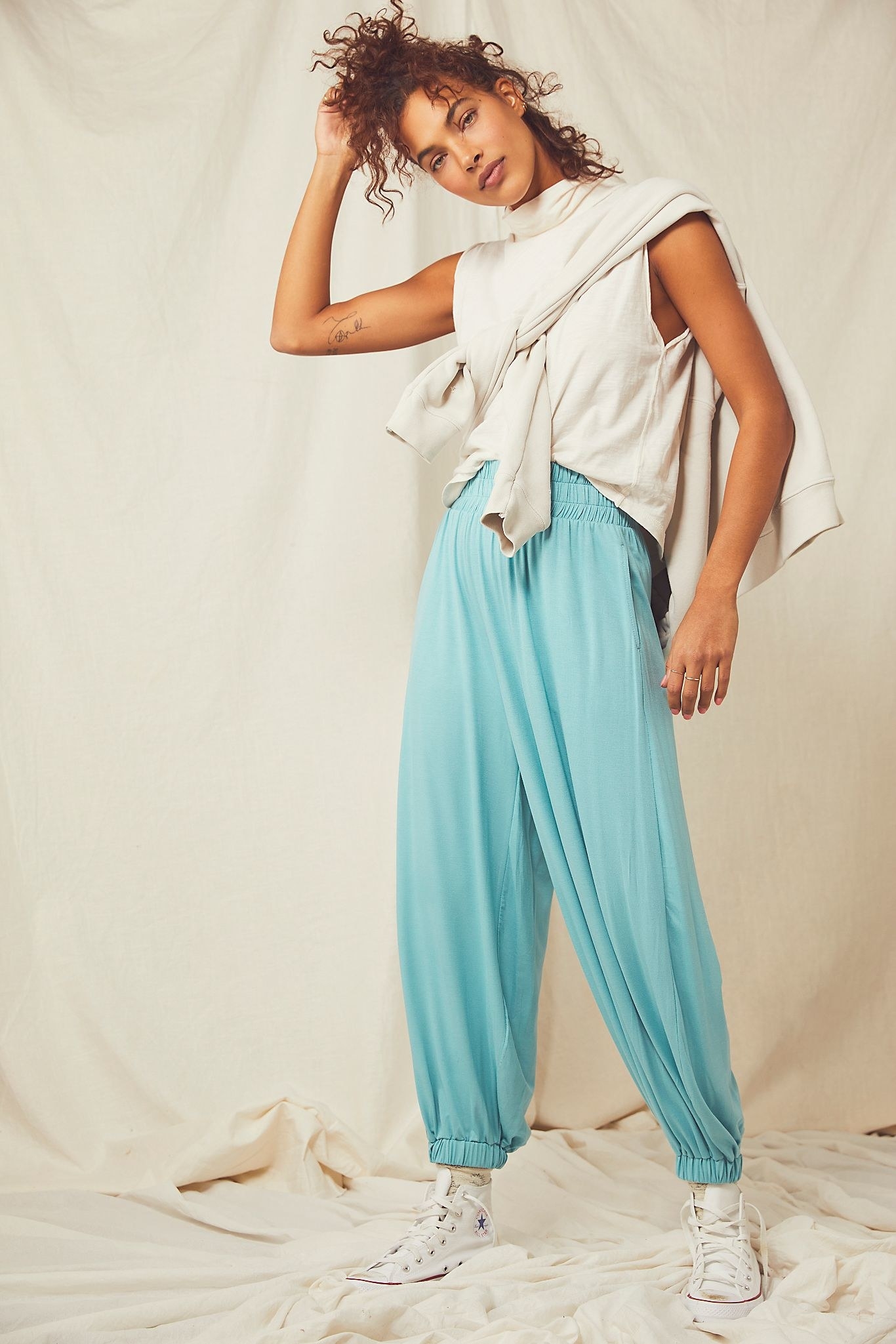 a model wearing the balloon pants in the color nile blue