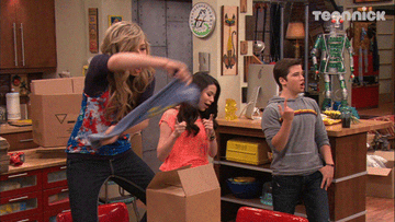 Sam standing on a chair dancing with a shirt and Freddi and Carly celebrating
