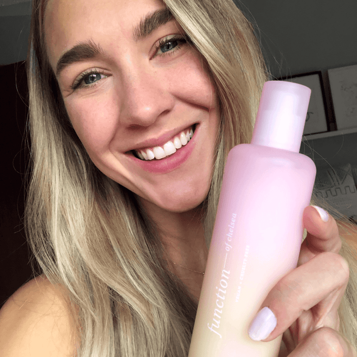 Model holding the facial cleanser 