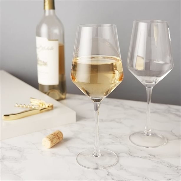 Two glasses of wine on a marble counter 