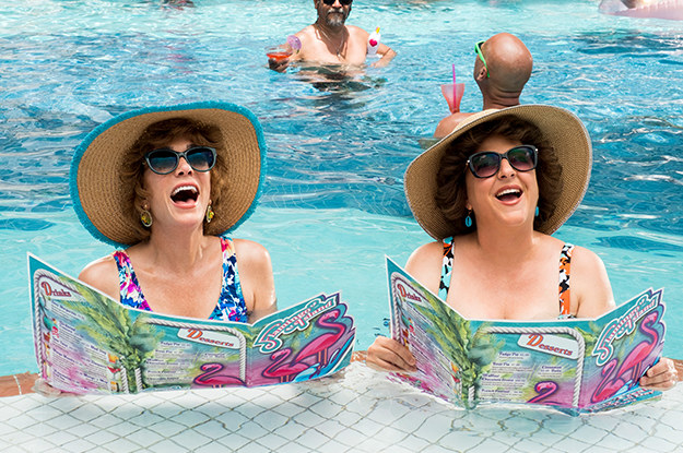 Kristen Wiig and Annie Mumolo as Barb and Star reading menus together in the pool.