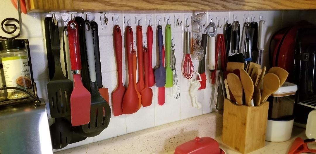Reviewer image using the hooks to hold up a variety of kitchen tools