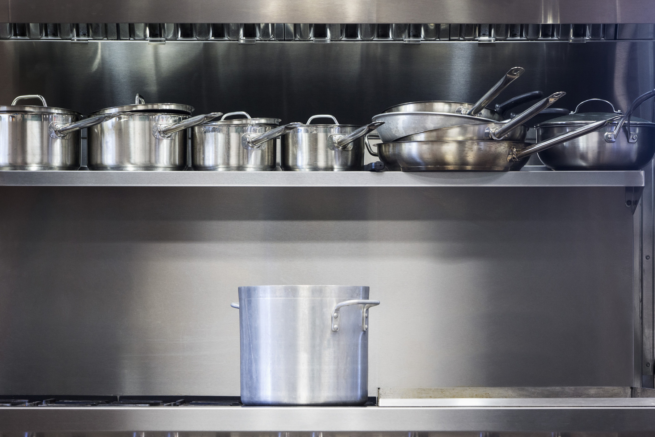 Steel pots and pans on shelves
