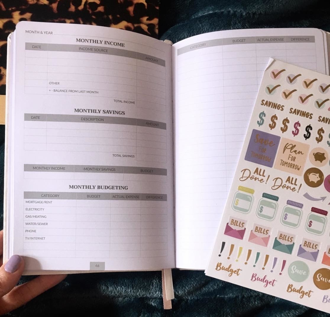 reviewer photo showing the budget planner open to a planning badge with the included sticker set 