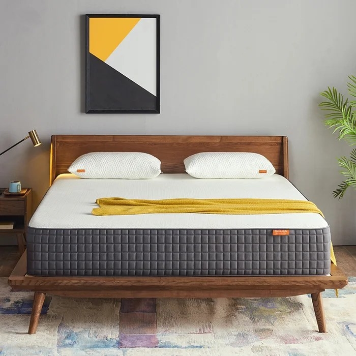 The mattress placed on top of a mid-century modern bed