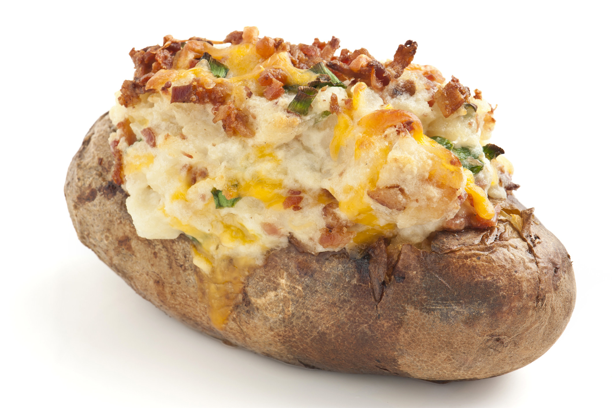Baked potato with various toppings, including bacon bits and cheese
