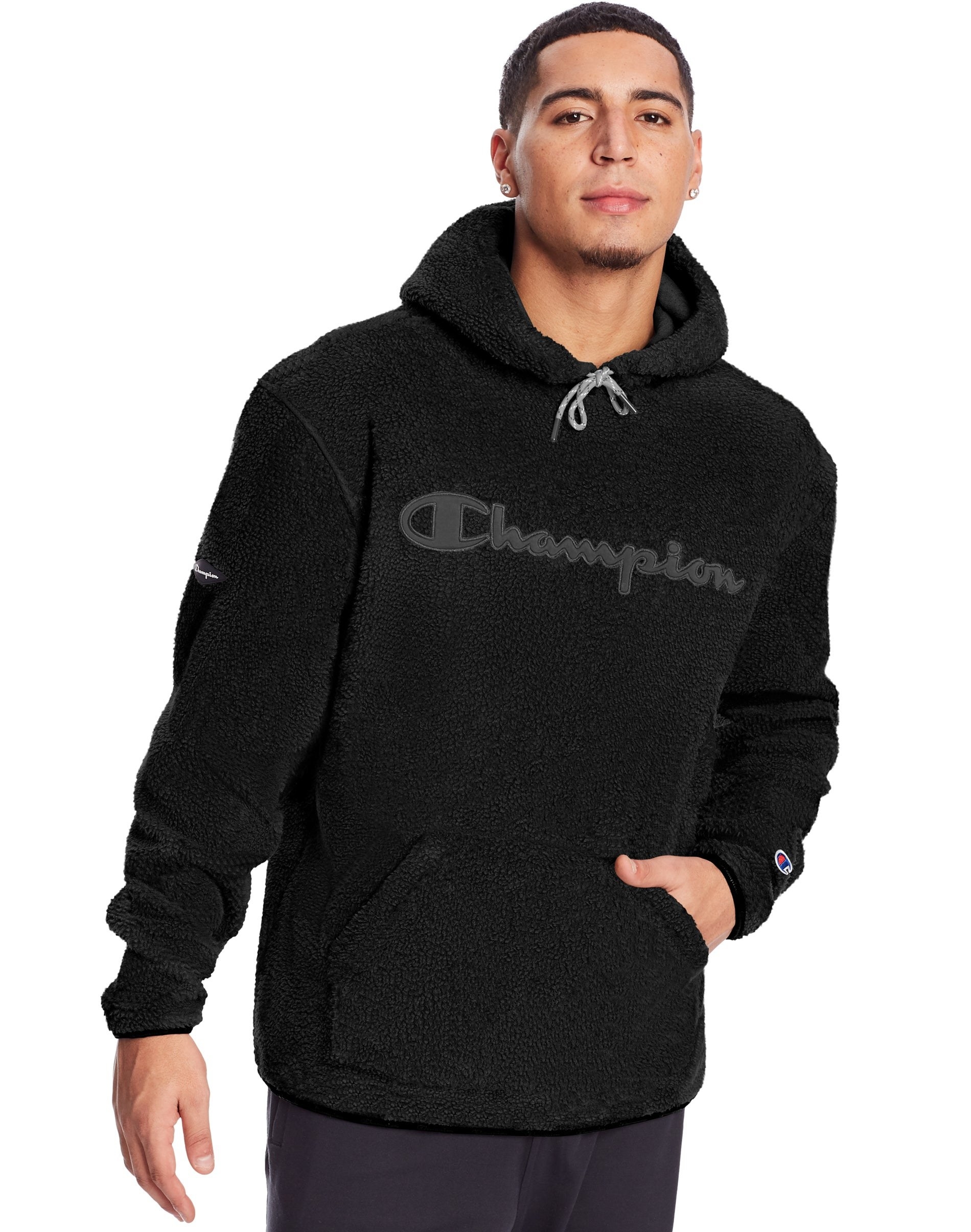 person wearing a black sherpa hoodie with &quot;champion&quot; on it