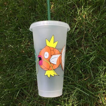 a starbucks cold tumbler cup with a magikarp on it