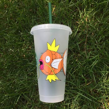 a starbucks cold tumbler cup with a magikarp on it