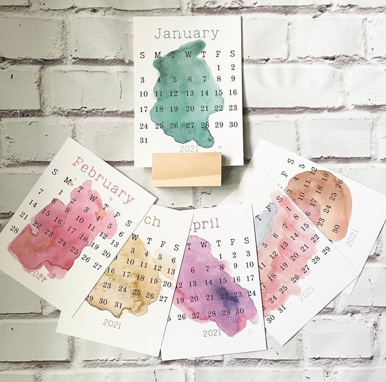 six months of the paper calendars with abstract watercolor backgrounds on the calendar cards