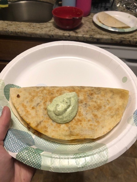 Quesadilla with cilantro sour cream on top