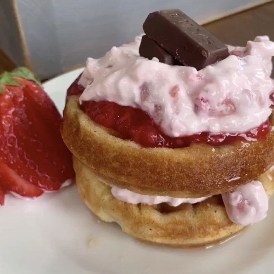 Two waffles with strawberry jam inbetween