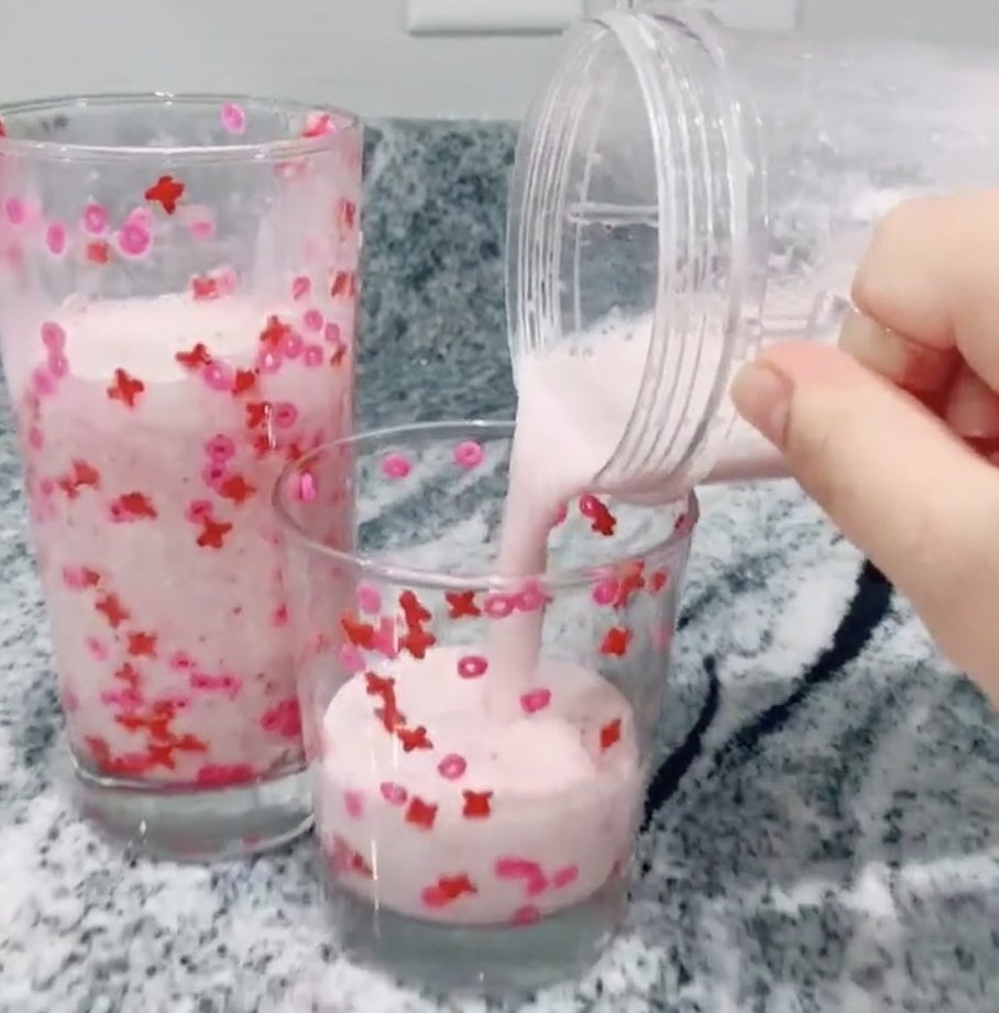 Cups filled with a pink drink and pink sprinkles