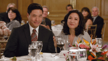 Randall Park and Constance Wu in the TV show Fresh Off the Boat reacting to good news