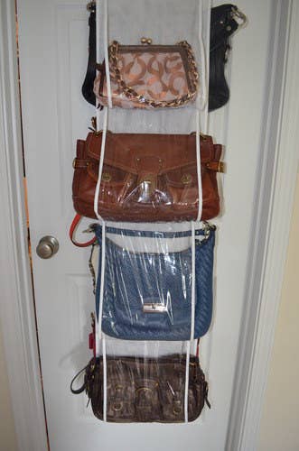 The organizer hanging over the door storing multiple purses
