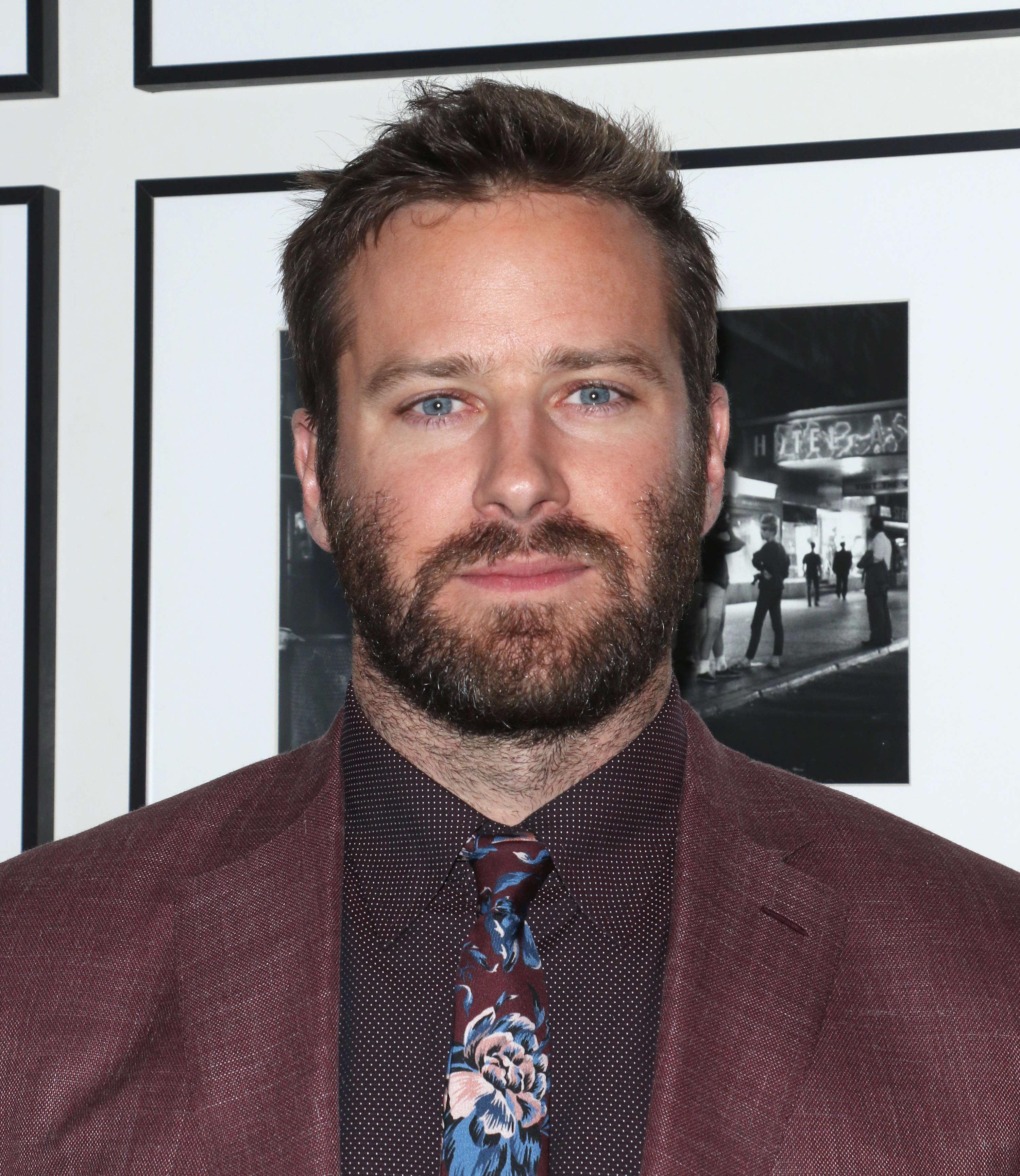 Hammer wears a suit with a patterned button-down and tie at the New York screening afterparty for Hotel Mumbai